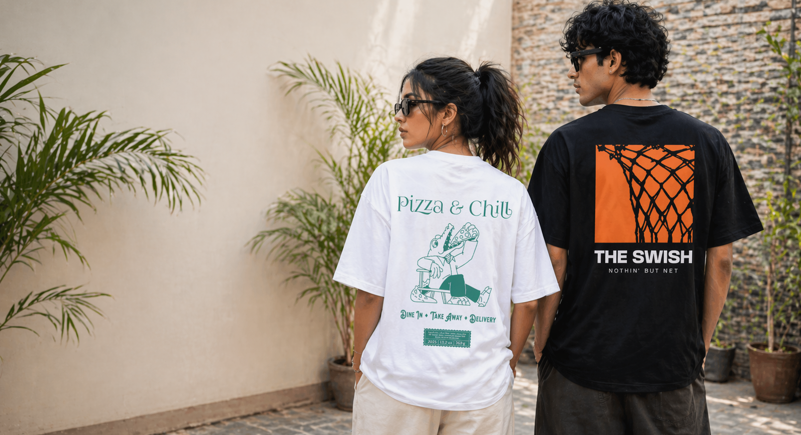 Two people wearing t-shirts with clean designs in an outdoor setting.
